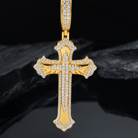Gold cross pendant with diamonds on a dark background